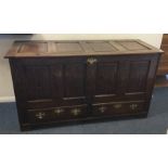 A large oak mule chest with hinged lid and brass h