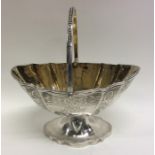 EXETER: A swing handled silver sugar basket with e