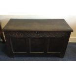 A good Georgian oak hinged top coffer with carved
