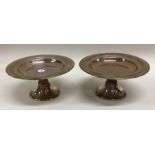 A pair of Edwardian silver tazzas on spreading fee