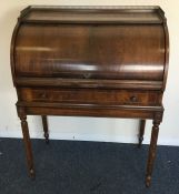 A reproduction cylinder top bureau on fluted suppo