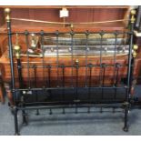 A brass and iron double bed. Est. £50 - £80.