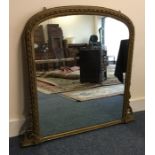 A Continental gilt over mantle mirror with shaped