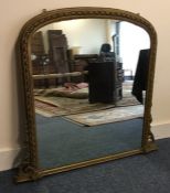A Continental gilt over mantle mirror with shaped