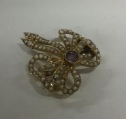 An amethyst and pearl 15 carat bow brooch with mat