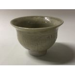 LOWERDOWN: A small celadon fluted bowl of textured