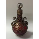 An Antique red glass scent bottle with brass overl