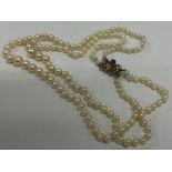 A double string of pearl beads with butterfly clas