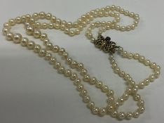 A double string of pearl beads with butterfly clas