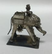 A silver figure of an elephant with textured body