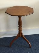 A octagonal pedestal table on three sweeping suppo