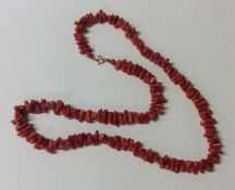 A coral twig necklace with gold clasp. Approx. 30