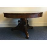 A Victorian mahogany pedestal dining table on thre