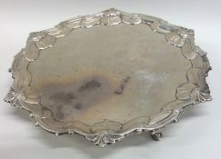 A Georgian silver salver with shell border. London