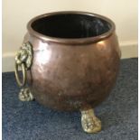 An old copper and brass log crock. Est. £20 - £30.