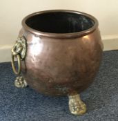 An old copper and brass log crock. Est. £20 - £30.