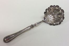 A large Continental silver sifter spoon with bead