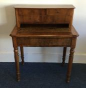 A Continental walnut desk on turned supports. Est.