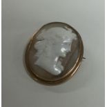 A small oval shell cameo of a lady's head in gold