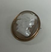 A small oval shell cameo of a lady's head in gold