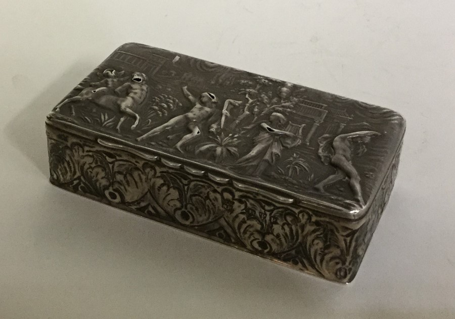 A silver embossed top box decorated with figures.