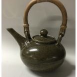 A small ovoid shaped lidded teapot with olive gree