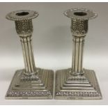 A pair of Edwardian silver candlesticks with flute