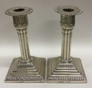 A pair of Edwardian silver candlesticks with flute