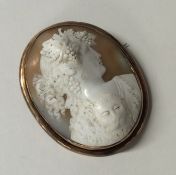 A gold framed cameo of a lady in relief. Approx. 2