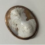 A gold framed cameo of a lady in relief. Approx. 2