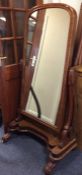 A Victorian mahogany dressing mirror on shaped sup