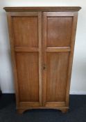 A mahogany two door cupboard on bracket feet. Est.