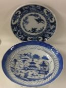 A Chinese blue and white plate decorated with buil