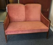 A pink upholstered and inlaid two seater settee. E