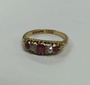 A Victorian 18 carat gold ruby and diamond ring. A