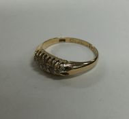 A small diamond five stone ring in claw mount. App