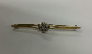 A pearl and gold bar brooch in 18 carat gold mount
