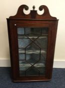 A Georgian mahogany corner cupboard with shaped to