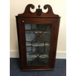 A Georgian mahogany corner cupboard with shaped to