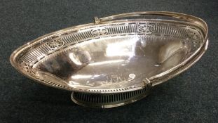 A large pierced George III silver basket on sweepi