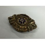 A Victorian target brooch decorated with enamel an