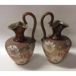 A pair of Royal Doulton ewers. Est. £20 - £30.