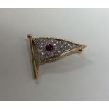 An unusual ruby and diamond brooch in the form of