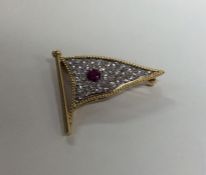 An unusual ruby and diamond brooch in the form of