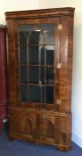 A large walnut veneered Antique corner cupboard wi