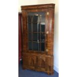 A large walnut veneered Antique corner cupboard wi