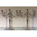 A pair of embossed silver plated candelabra. Est.