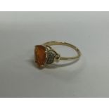 An 18 carat gold fire opal and diamond ring. Appro