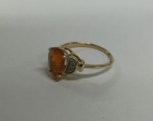 An 18 carat gold fire opal and diamond ring. Appro