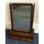 A Georgian mahogany toilet mirror with two drawers